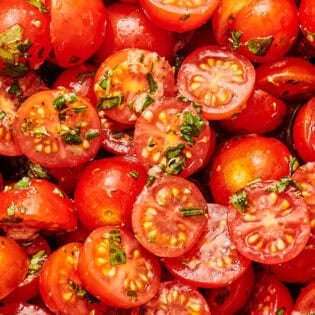 A close up of marinated tomatoes.