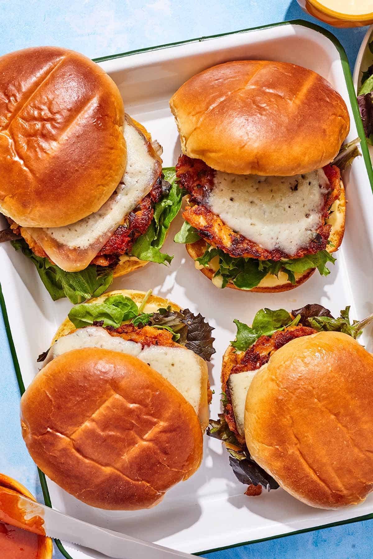 Four tuna burgers on a platter.