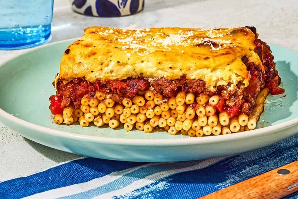 A slice of the pastitsio recipe on a plate.