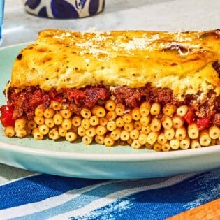 A slice of the pastitsio recipe on a plate.