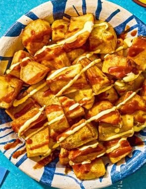 Fried potatoes for the patatas bravas in a serving bowl.