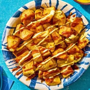 Fried potatoes for the patatas bravas in a serving bowl.