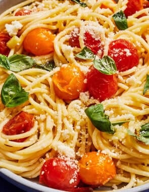A serving of cherry tomato pasta in a bowl.