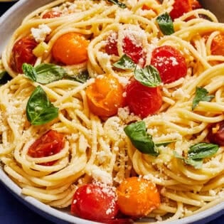 A serving of cherry tomato pasta in a bowl.