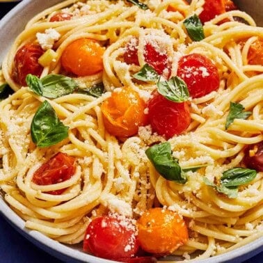 A serving of cherry tomato pasta in a bowl.