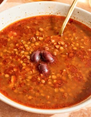 Greek lentil soup in a bowl with a spoon.