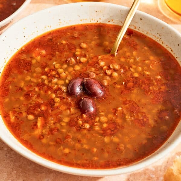 Greek lentil soup in a bowl with a spoon.