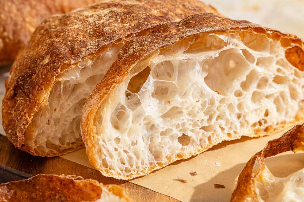 Slices of pan de cristal on a cutting board.
