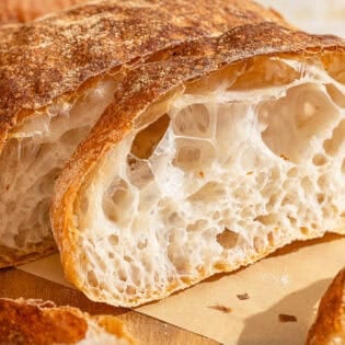 Slices of pan de cristal on a cutting board.