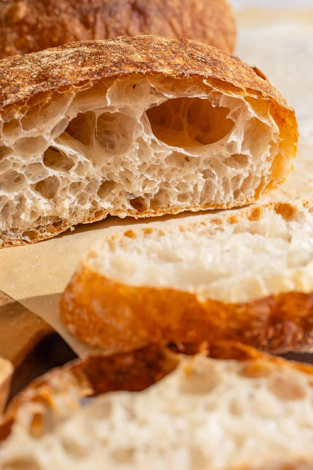 Slices of pan de cristal on a cutting board.