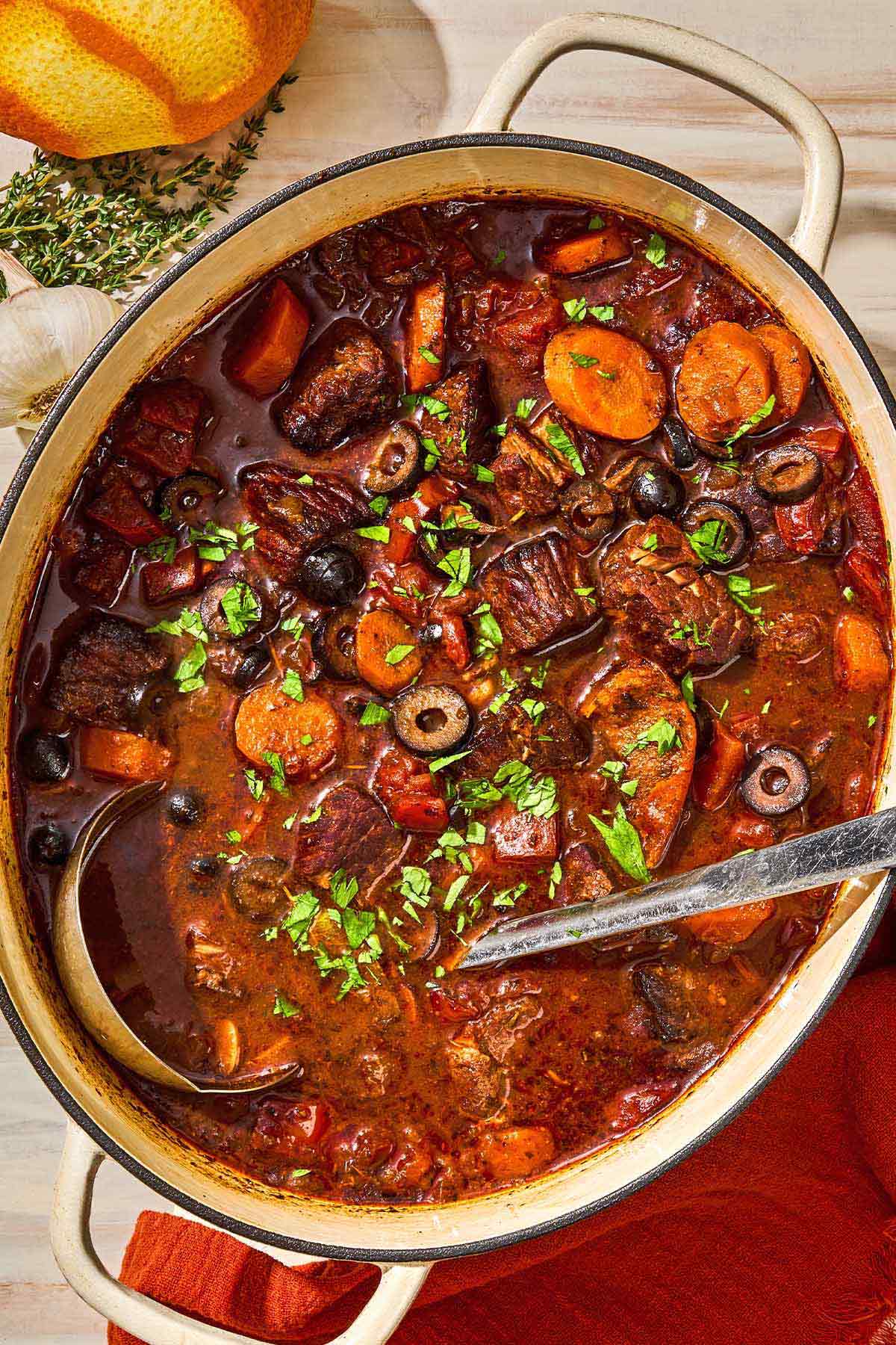 A pot of daube provencal with a ladle.