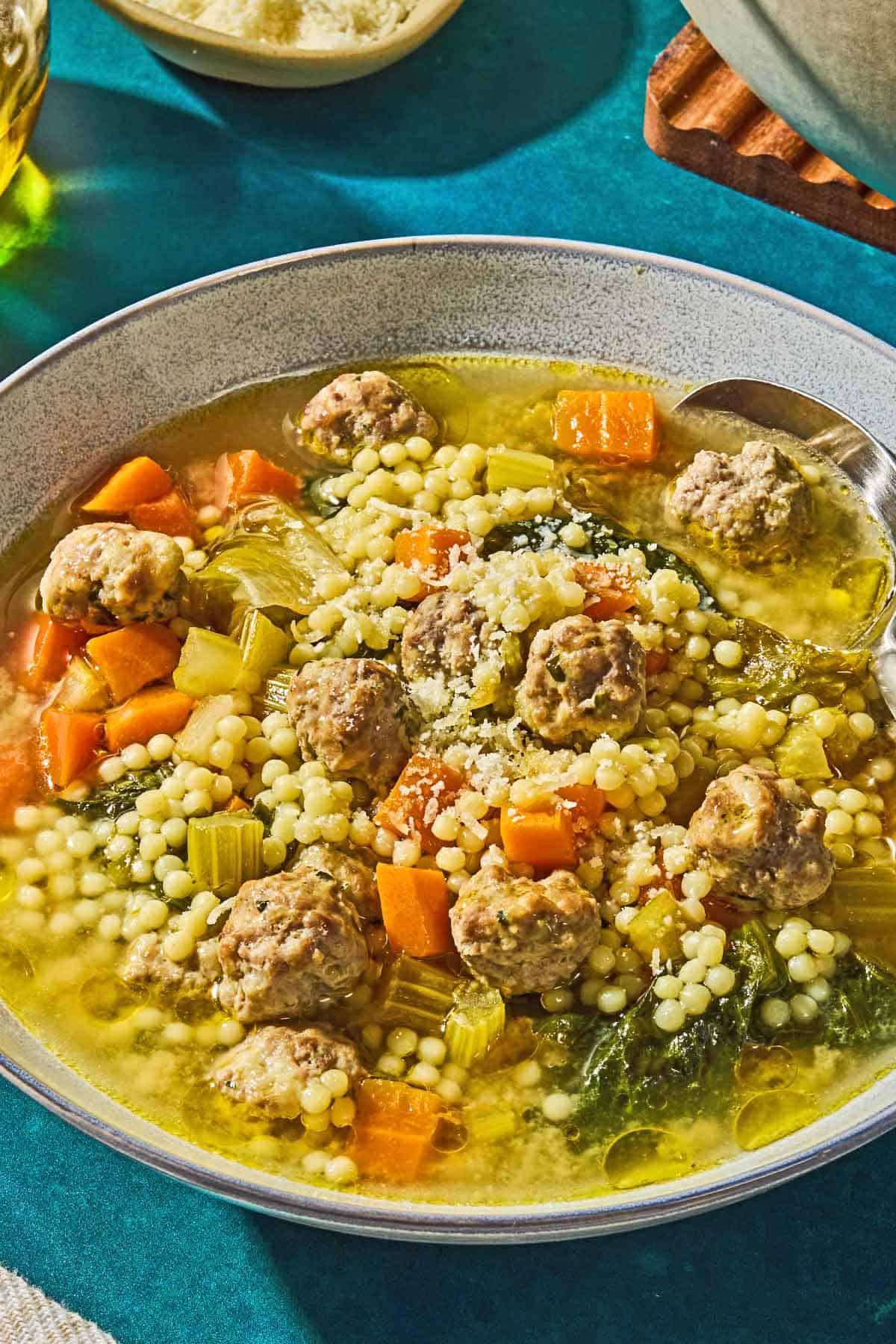 Italian wedding soup in a bowl with a spoon.