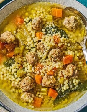 Italian wedding soup in a bowl with a spoon.