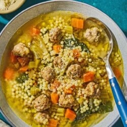 Italian wedding soup in a bowl with a spoon.