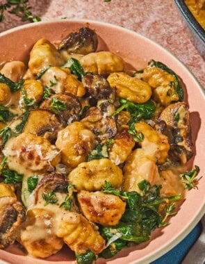 Mushroom gnocchi in a bowl next to a fork.