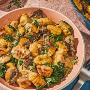 Mushroom gnocchi in a bowl next to a fork.