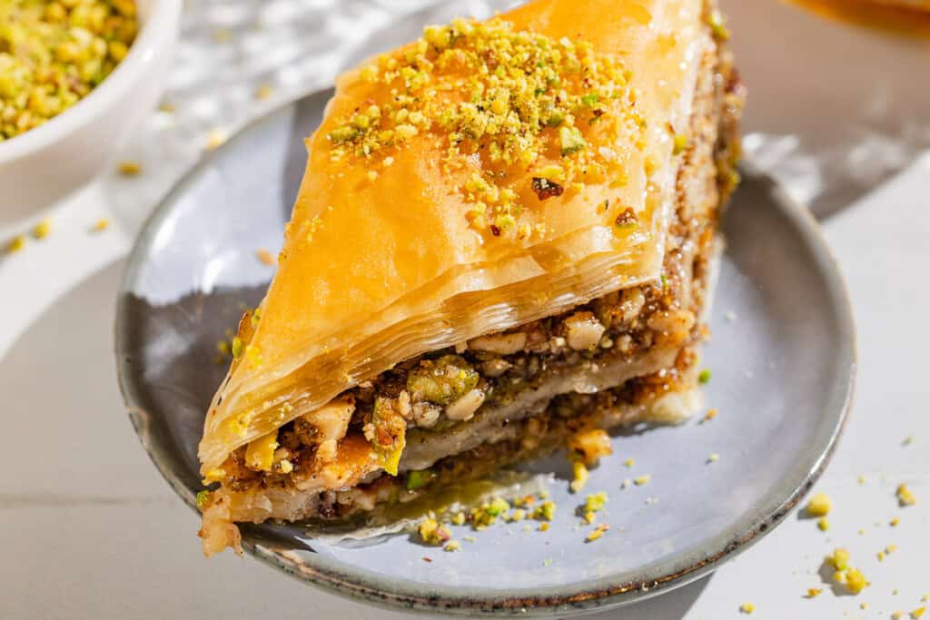 A slice of baklava on a plate.
