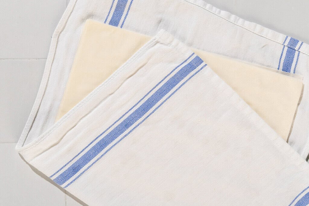 Unrolled phyllo pastry placed in a kitchen towel.