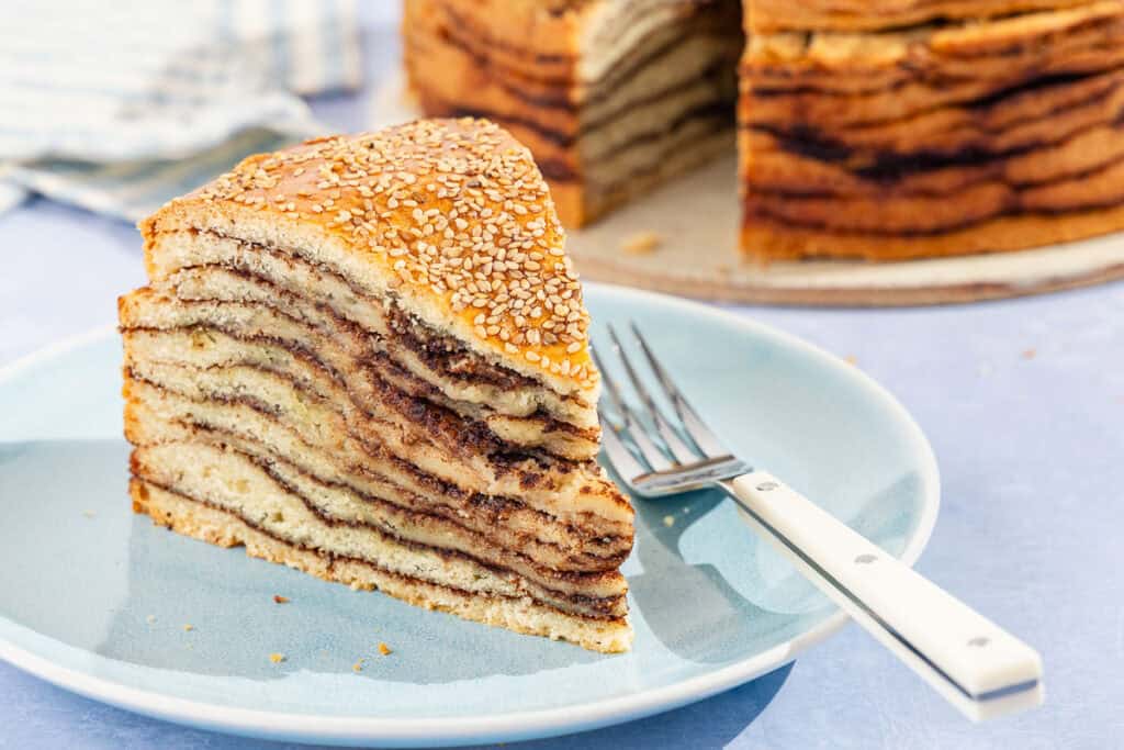 A slice of vasilopita on a plate with a fork.