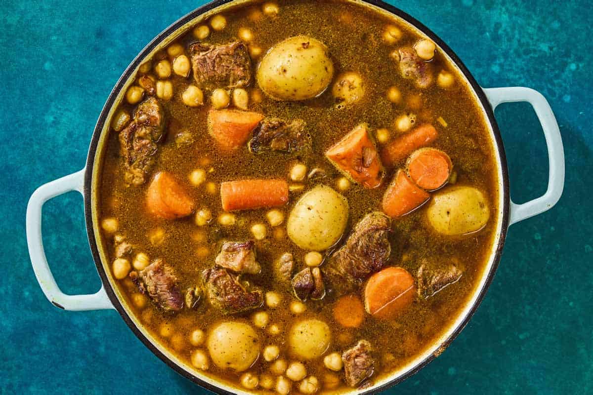 The beef tagine slow cooking in a skillet.