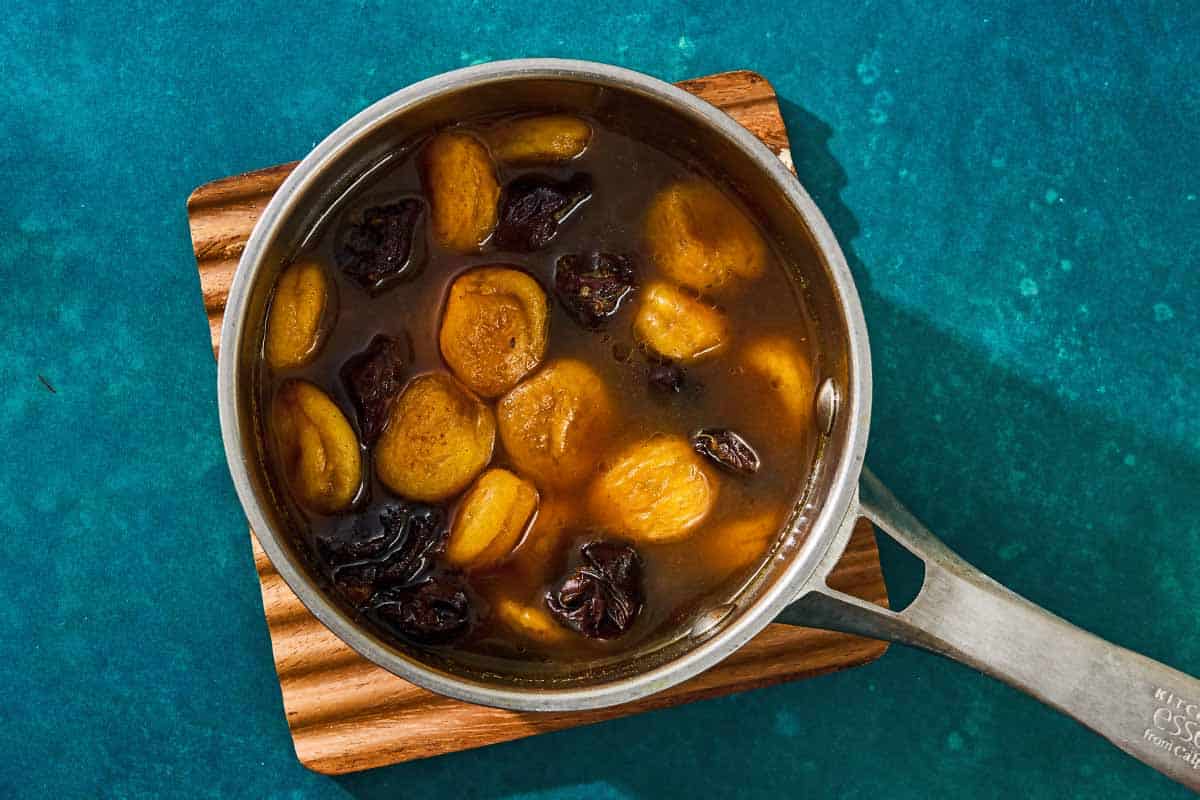 The dried fruit and braising liquid, honey and water combined in a saucepan to make the fruit compote for the beef tagine.